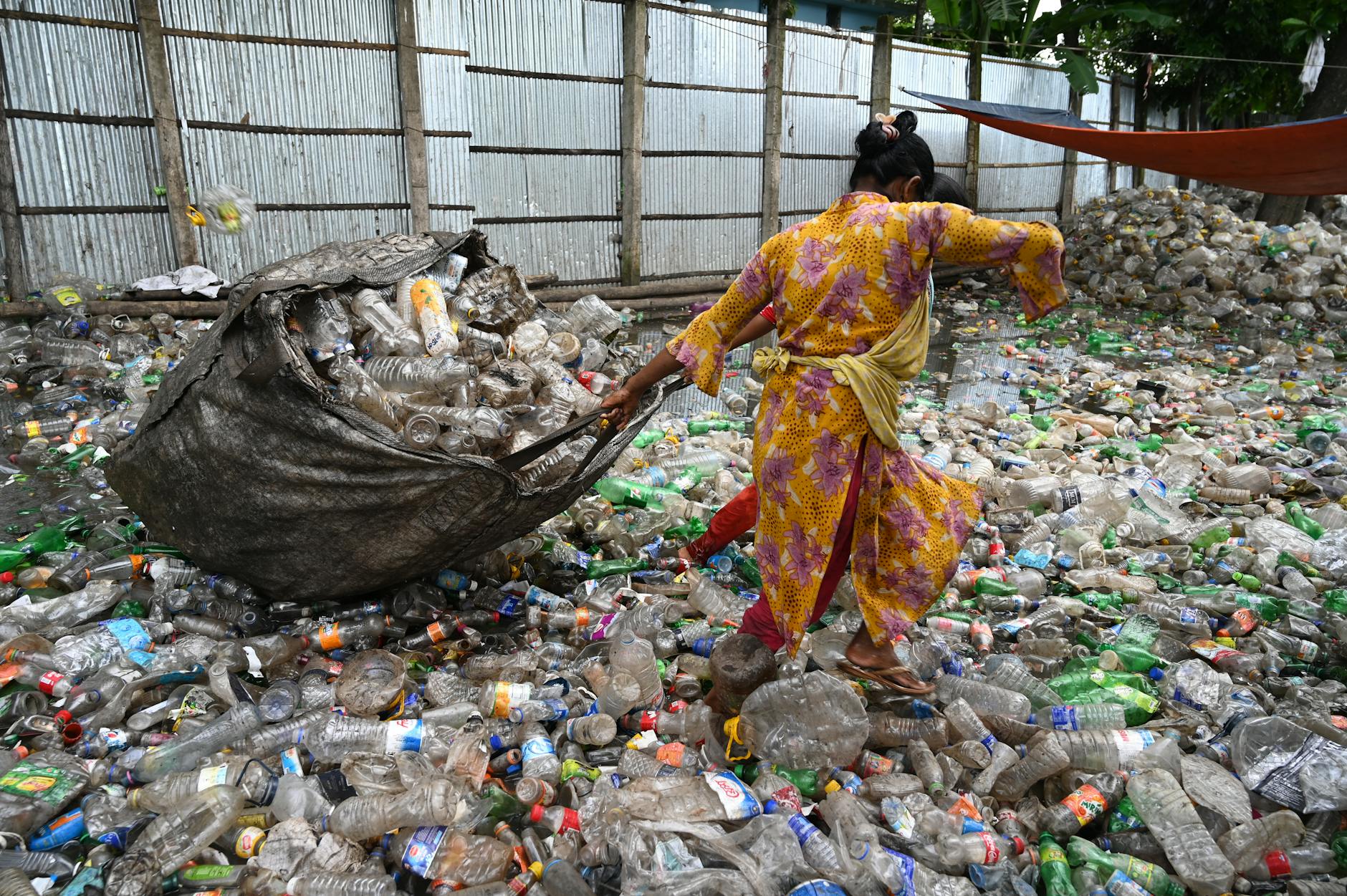 person pulling a sack of garbage