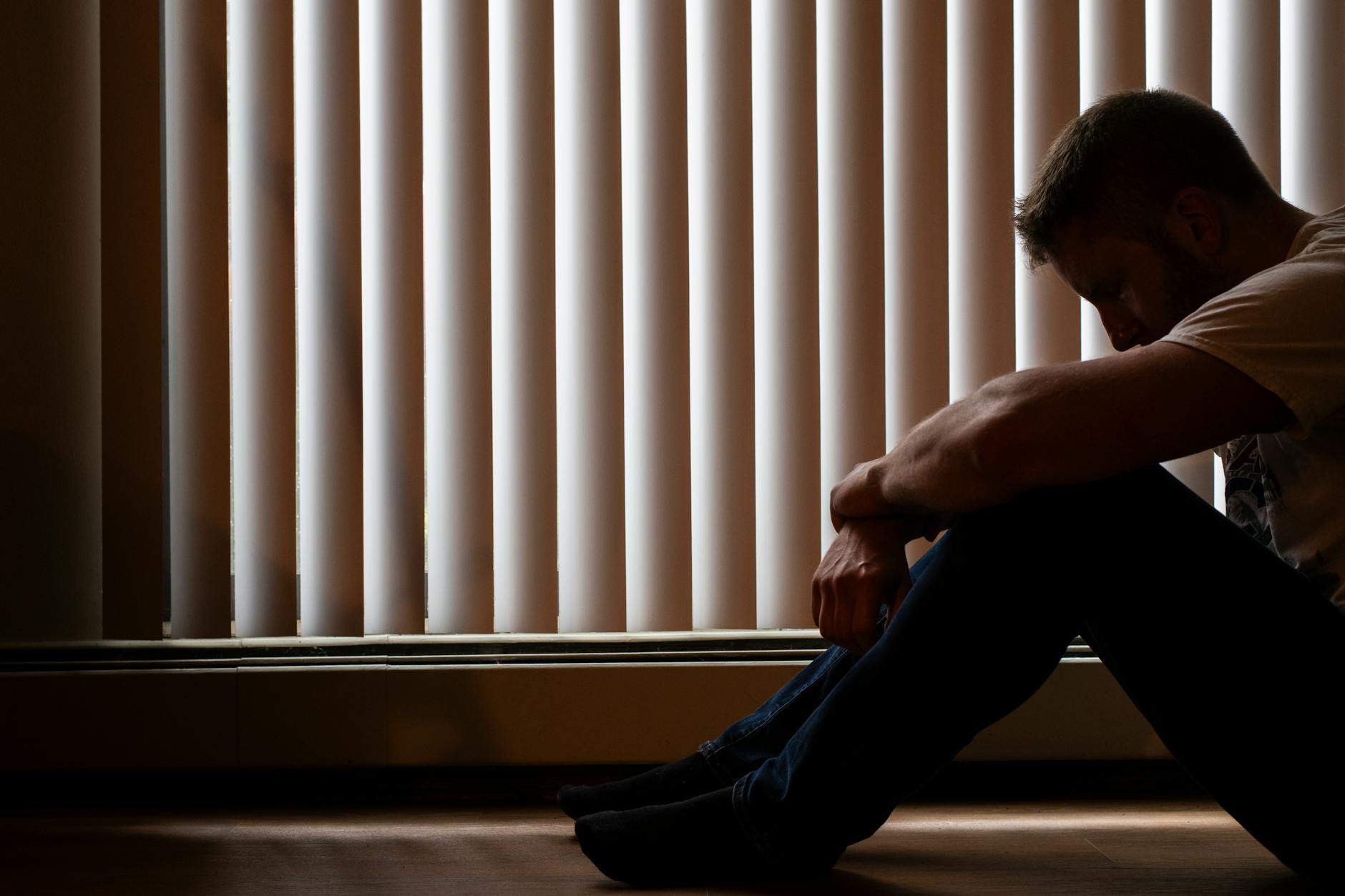 silhouette of man sitting in contemplation